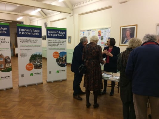People talking and looking at exhibition.