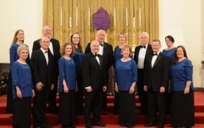 Eleven male and female choir members in smart dress.