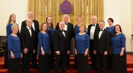 Eleven male and female choir members in smart dress.