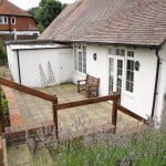 Patio area at rear of white walled village hall