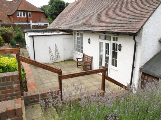 Patio area at rear of white walled village hall