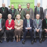 10 males and 2 females sitting after receiving awards.