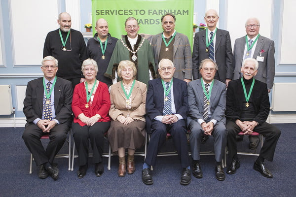 10 males and 2 females sitting after receiving awards.