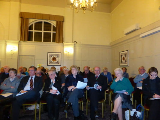 People sitting in room at a meeting.