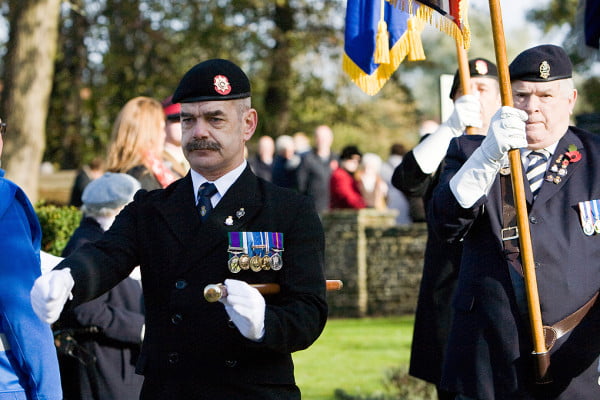 3 males, taking part in a parade.
