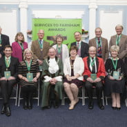 Two rows of people holding awards. Mayor and Mayoress.