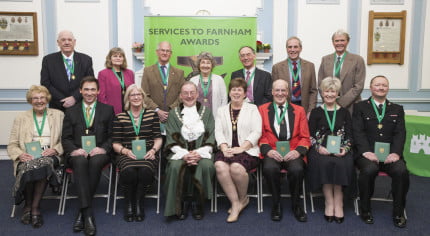 Two rows of people holding awards. Mayor and Mayoress.