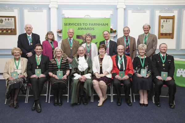 Two rows of people holding awards. Mayor and Mayoress.