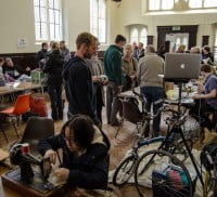 group of people chatting, people repairing objects.