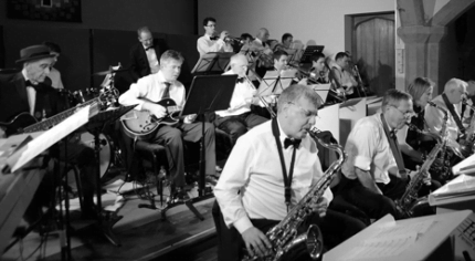 Black and white photo of band members playing musical instruments