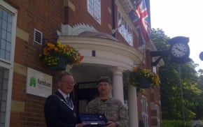 Mayor and soldier outside council offices.