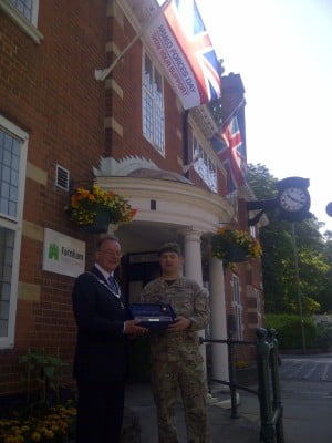 Mayor and soldier outside council offices.
