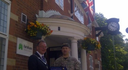 Mayor and soldier outside council offices.