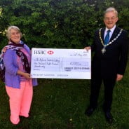 Mayor hands large cheque to lady.