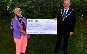 Mayor hands large cheque to lady.
