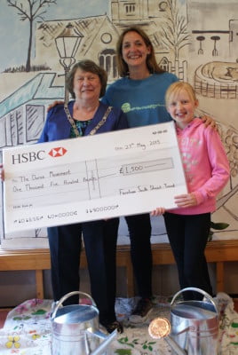 Three people including the Mayor with a large cheque.