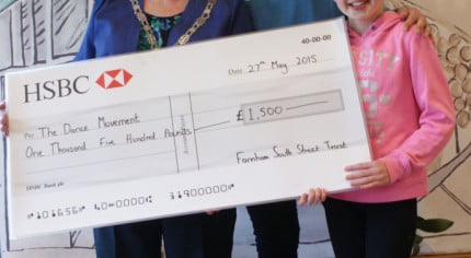 Three people including the Mayor with a large cheque.