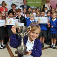 group of children holding awards.