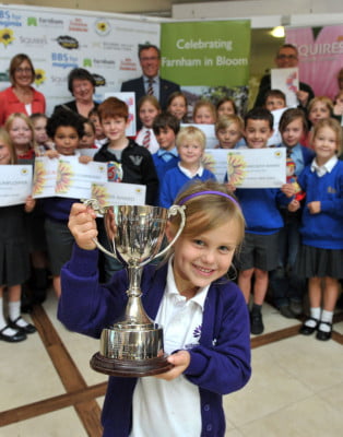 group of children holding awards.