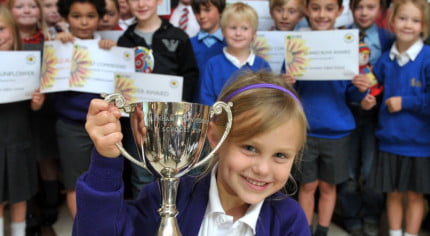 group of children holding awards.