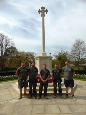 Five males in front of war memorial
