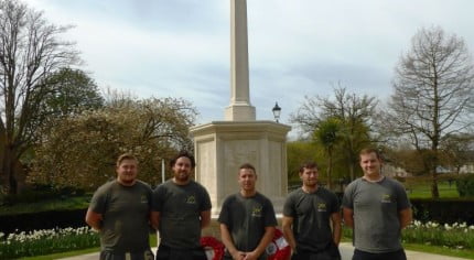 Five males in front of war memorial