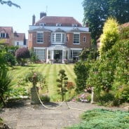 View of period house with beautiful garden in front