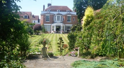 View of period house with beautiful garden in front