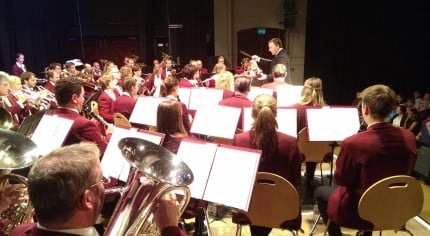 A group of children and adults playing musical instruments