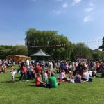 Many groups of friends and families in a green open space