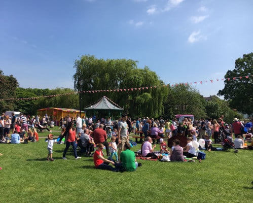 Many groups of friends and families in a green open space