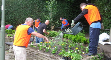 Six males gardening raised beds.