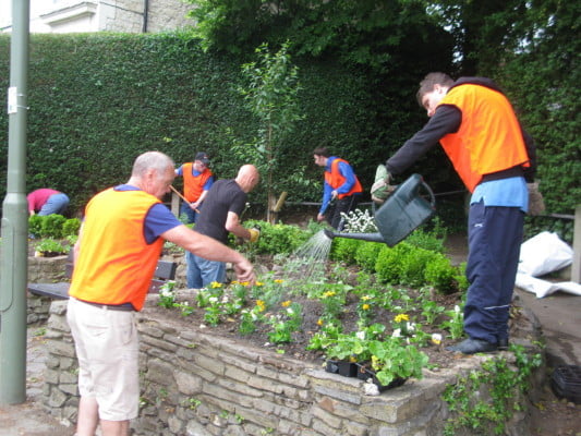 Six males gardening raised beds.