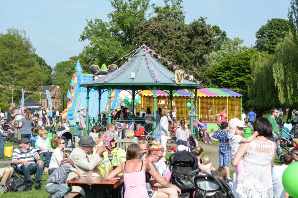 Crowds watching a band perform in the park