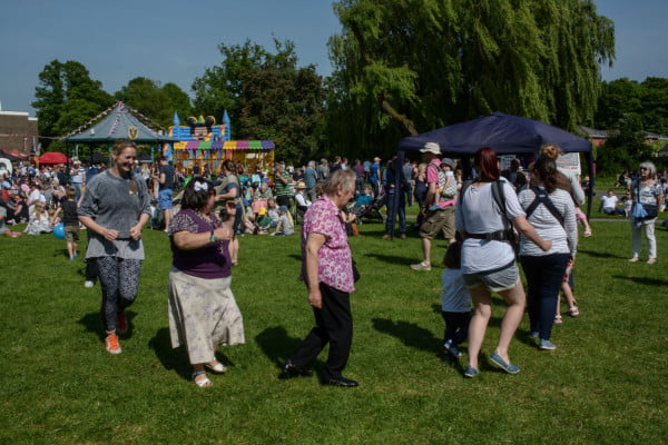 A group of females dancing in the park