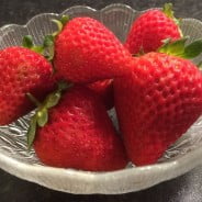 A glass bowl of strawberries.