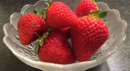 A glass bowl of strawberries.