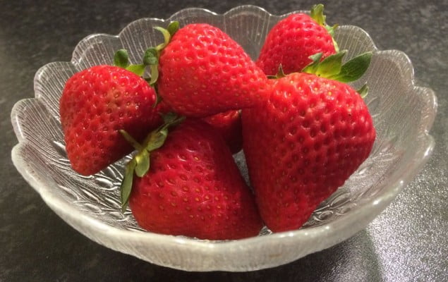 A glass bowl of strawberries.