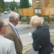 Judges looking at a garden area in a street.