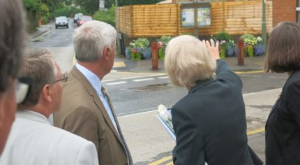 Judges looking at a garden area in a street.