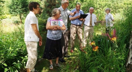 Group of judges in a garden.