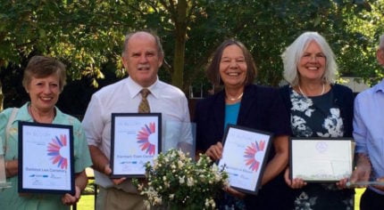 Group of people holding certificates.