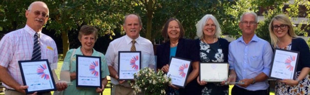 Group of people holding certificates.