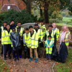 Group of young people with litter pickers and black sacks.