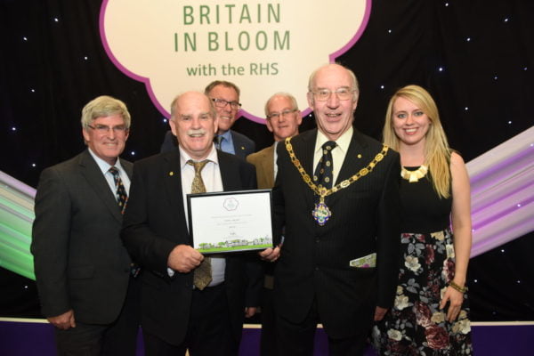 Group of people with a certificate.