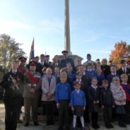 Group of children in front of war memorial