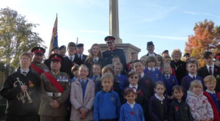 Group of children in front of war memorial