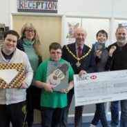 Group of young people with the Mayor and a large cheque.