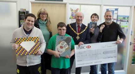 Group of young people with the Mayor and a large cheque.