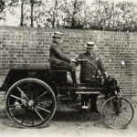 Man and boy with old fashioned car.